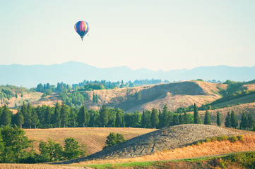 Air balloon over Tuscany landscape, Italy.