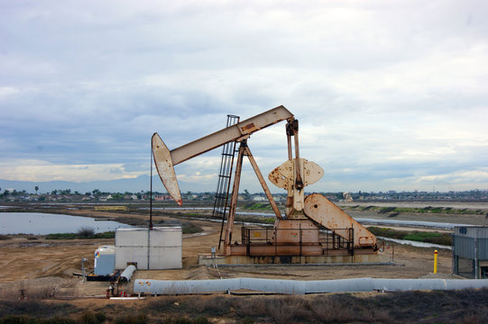 Oil Derrick With Cloudy Sky