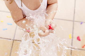 Fototapeta premium Woman splashing a water ballon. Concept about end of the summer