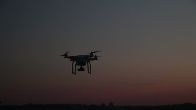 Quadrocopter Flight Over The Water on The River Bank at Sunset