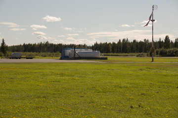 Fuel tanks on an air field with the wind gauge blowing in the wind