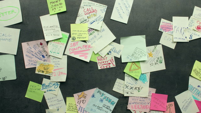 Post-it notes appearing on dark background - busy concept - stop motion animation