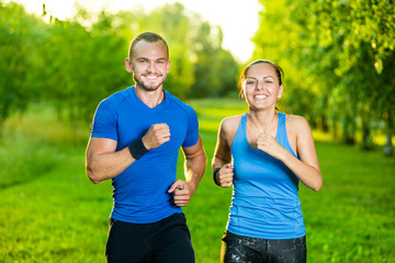 Runners training outdoors working out. City running couple