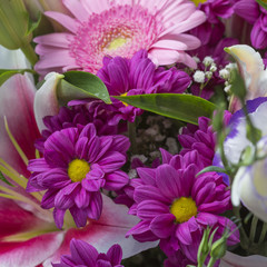 Obraz premium Flower bouquet close up with purple flowers and green leaves