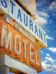 Obraz premium aged and worn vintage photo of neon motel sign