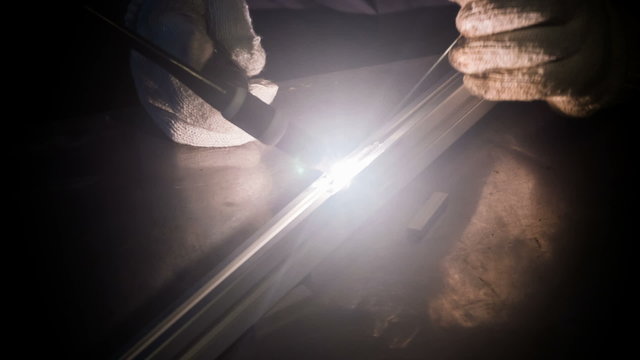 Welding man, welds  tube