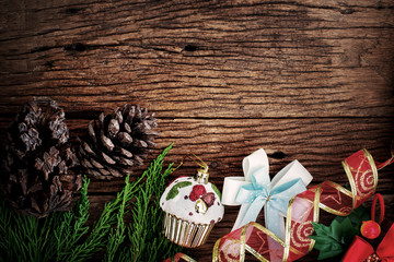 Christmas pine tree with decoration on wooden board background with copy space (Vintage color tone)