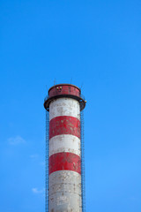 
A single industrial chimney, blue sky
