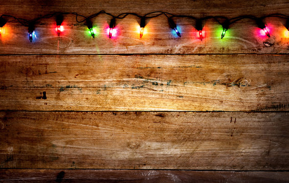 Christmas rustic background - vintage planked wood with colorful lights and free text space