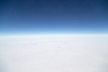 Naklejka na ściany i meble snowy land. view from the airplane