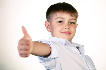 Smiling boy gesturing with his thumb up