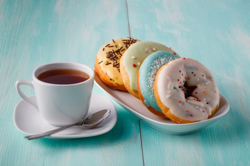 Four donuts on old wood table