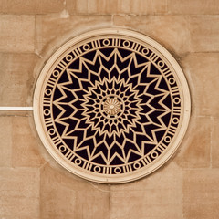 Round window decorated with rosette 