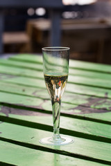 Champagne glass on painted wood table