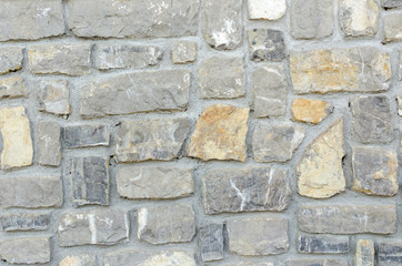texture of the wall made of stone with mortar joints