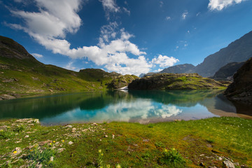 Fototapeta na wymiar Small high mountain lake with transparent