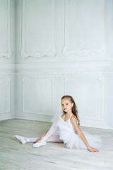A little adorable young ballerina in a playful mood in the inter © jutaphoto