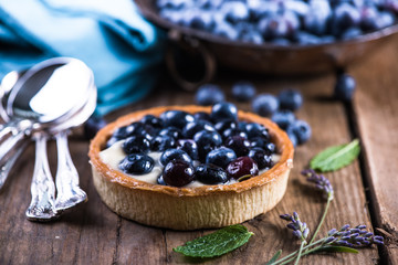 Homemade blueberry tart on wooden table