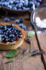 Homemade blueberry tart on wooden table