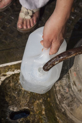 Filling canister public fountain, Rome, Italy