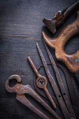 vintage rusted tools on dark board