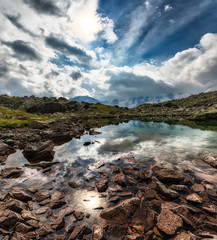 Small high mountain lake with transparent