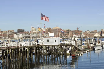 Papier Peint photo autocollant Ville sur leau Large American flag flies in Portland Harbor with south Portland skyline, Portland, Maine