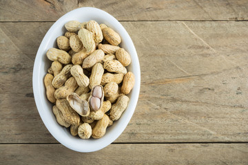 Boiled peanuts on wooden background.