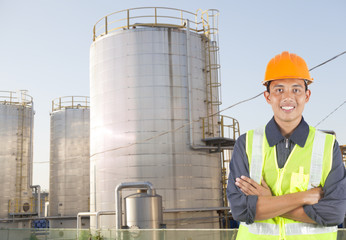 Portrait of asian engineer standing with oil gas refinery in the background