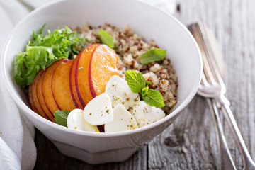 Quinoa bowl with peach and mozarella
