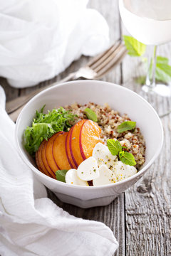 Quinoa bowl with peach and mozarella