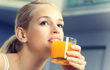 woman drinking orange juice © vgstudio