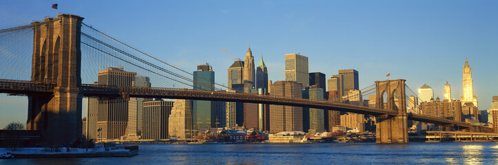 Fototapeta na wymiar Panoramic view of Brooklyn Bridge and East River at sunrise with New York City, NY skyline post 9/11 view
