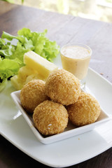 Fried cheese ball with salad in the dish