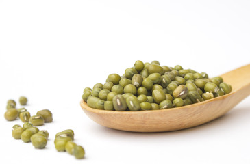 Green beans on wooden spoon isolated on white background