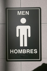 Symbol for man, hombres, in front of airport bathroom