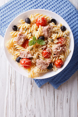 fusilli pasta with tuna, tomatoes and parmesan. vertical top view
