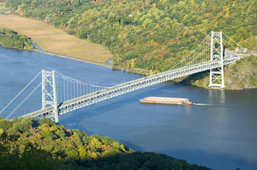 Autumn view overlook of Bear Mountain Bridge, trash barge and Hudson Valley and River at Bear Mountain State Park, New York