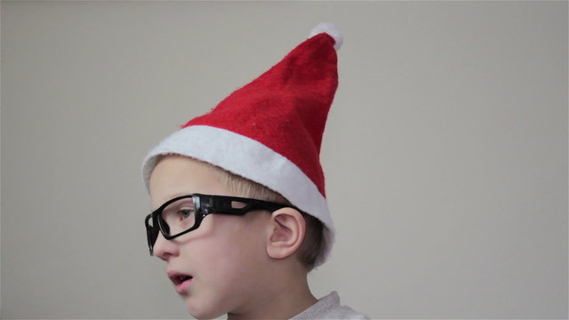 Boy Santa Claus/boy looks closely Santa Christmas TV transmission in the festive season