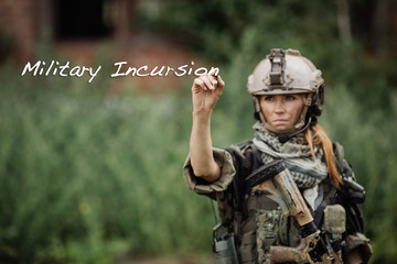 woman soldier writes marker on transparent glass