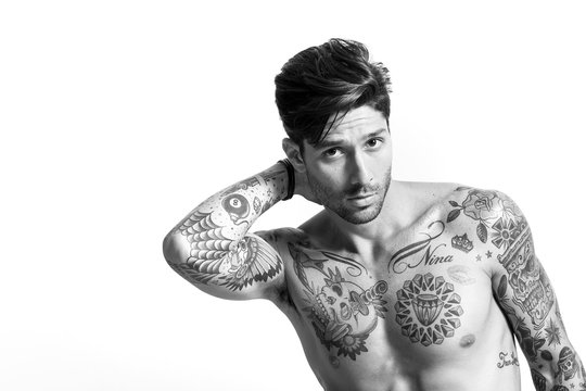 Handsome tattooed man portrait posing black and white