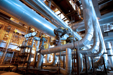 Equipment, cables and piping as found inside of a modern industrial power plant