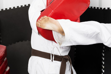 Closeup of two young men in kimono training martial arts, the te