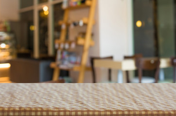checkered table cloth on empty table and restaurant or cafe for