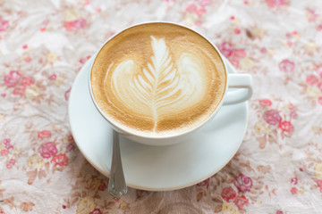 Cup of art latte or cappuccino coffee with retro filter effect a