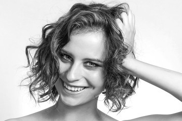 Fototapeta premium Smiling beautiful girl closeup portrait black and white