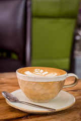 Hot art Latte Coffee in a cup on wooden table.