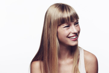 Naklejka premium Happy and smiling young blond woman in studio