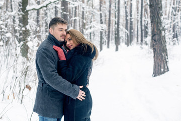 Portrait of happy couple in winter park