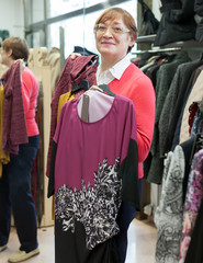 Mature woman choosing     blouse